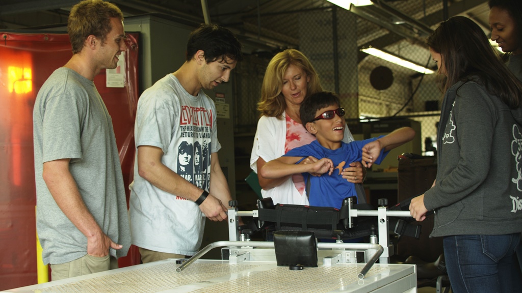 Four senior engineering students collaborate to build an assistive standing device for a 10 year old boy learning to walk.
